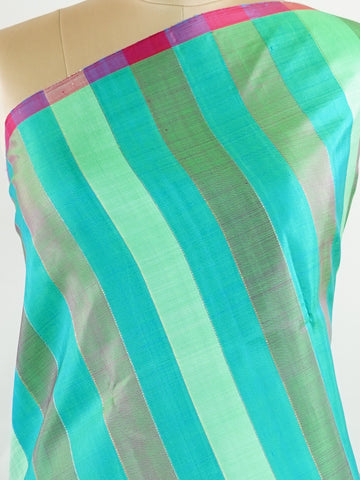 Kanchipuram Silk A masterpiece from Kanchipuram, this Kanjivaram saree in Green Brown  is a tribute to India's rich handloom legacy. The Pure Zari weaving and Buttis  motifs make it a perfect choice for brides and celebrations. Every thread speaks of elegance, tradition, and the skilled hands that bring this saree to life. Kambhoji - Manoranjitham Weaves - Handloom Store
