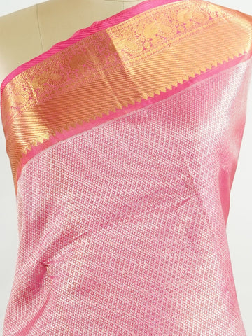 Kanchipuram Silk This 100% Pure Silk  silk saree, adorned in Hot Pink and detailed with Pure Zari weaving, reflects the grandeur of Maharashtra. The timeless Buttis motifs enhance its bridal charm. A perfect blend of luxury and tradition, it is designed for those who appreciate fine craftsmanship. Bageshree - Pure Kanjivaram Silk Saree | Pure Zari - Manoranjitham Weaves - Handloom Store