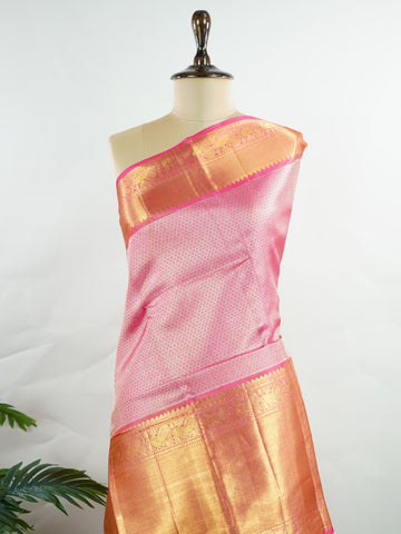 Kanchipuram Silk This 100% Pure Silk  silk saree, adorned in Hot Pink and detailed with Pure Zari weaving, reflects the grandeur of Maharashtra. The timeless Buttis motifs enhance its bridal charm. A perfect blend of luxury and tradition, it is designed for those who appreciate fine craftsmanship. Bageshree - Pure Kanjivaram Silk Saree | Pure Zari - Manoranjitham Weaves - Handloom Store