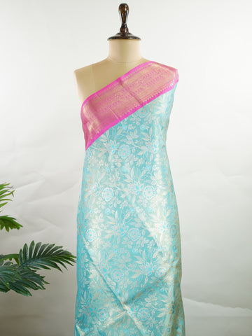 Kanchipuram Silk Handwoven by skilled artisans of Maharashtra, this 100% Pure Silk  saree in Aqua Green blends traditional elegance with intricate Pure Zari zari work. A truly stunning drape for special occasions. The interplay of colors and craftsmanship makes it a treasured piece for every saree connoisseur. Joga - Aqua Pure Kanjivaram Silk Saree | Pure Zari - Manoranjitham Weaves - Handloom Store