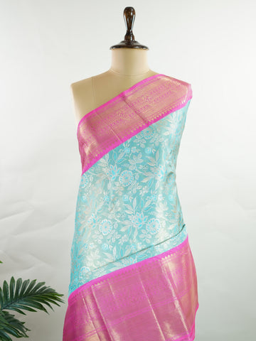 Kanchipuram Silk Handwoven by skilled artisans of Maharashtra, this 100% Pure Silk  saree in Aqua Green blends traditional elegance with intricate Pure Zari zari work. A truly stunning drape for special occasions. The interplay of colors and craftsmanship makes it a treasured piece for every saree connoisseur. Joga - Aqua Pure Kanjivaram Silk Saree | Pure Zari - Manoranjitham Weaves - Handloom Store