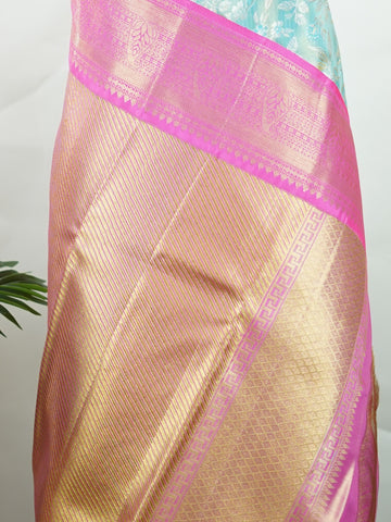 Kanchipuram Silk Handwoven by skilled artisans of Maharashtra, this 100% Pure Silk  saree in Aqua Green blends traditional elegance with intricate Pure Zari zari work. A truly stunning drape for special occasions. The interplay of colors and craftsmanship makes it a treasured piece for every saree connoisseur. Joga - Aqua Pure Kanjivaram Silk Saree | Pure Zari - Manoranjitham Weaves - Handloom Store