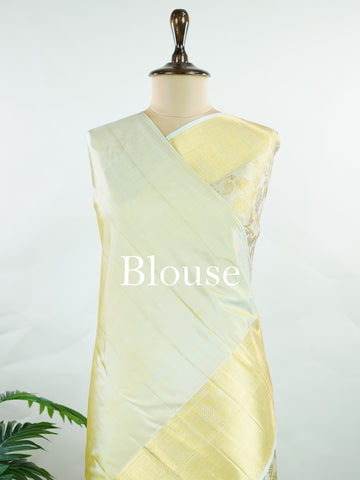 Kanchipuram Silk This 100% Pure Silk  silk saree, adorned in Butter yellow and detailed with Pure Zari weaving, reflects the grandeur of Maharashtra. The timeless Buttis motifs enhance its bridal charm. A perfect blend of luxury and tradition, it is designed for those who appreciate fine craftsmanship. Tilak - Pure Kanjivaram Silk Saree | Pure Zari - Manoranjitham Weaves - Handloom Store