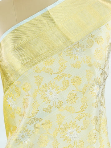 Kanchipuram Silk This 100% Pure Silk  silk saree, adorned in Butter yellow and detailed with Pure Zari weaving, reflects the grandeur of Maharashtra. The timeless Buttis motifs enhance its bridal charm. A perfect blend of luxury and tradition, it is designed for those who appreciate fine craftsmanship. Tilak - Pure Kanjivaram Silk Saree | Pure Zari - Manoranjitham Weaves - Handloom Store
