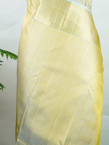Kanchipuram Silk This 100% Pure Silk  silk saree, adorned in Butter yellow and detailed with Pure Zari weaving, reflects the grandeur of Maharashtra. The timeless Buttis motifs enhance its bridal charm. A perfect blend of luxury and tradition, it is designed for those who appreciate fine craftsmanship. Tilak - Pure Kanjivaram Silk Saree | Pure Zari - Manoranjitham Weaves - Handloom Store