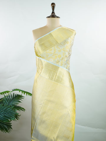 Kanchipuram Silk This 100% Pure Silk  silk saree, adorned in Butter yellow and detailed with Pure Zari weaving, reflects the grandeur of Maharashtra. The timeless Buttis motifs enhance its bridal charm. A perfect blend of luxury and tradition, it is designed for those who appreciate fine craftsmanship. Tilak - Pure Kanjivaram Silk Saree | Pure Zari - Manoranjitham Weaves - Handloom Store