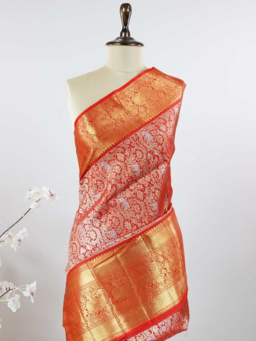 Kanchipuram Silk This 100% Pure Silk  silk saree, adorned in Red and detailed with Pure Zari weaving, reflects the grandeur of Maharashtra. The timeless Buttis motifs enhance its bridal charm. A perfect blend of luxury and tradition, it is designed for those who appreciate fine craftsmanship. Hemanta - Red Pure Kanjivaram Silk Saree | Pure Zari - Manoranjitham Weaves - Handloom Store