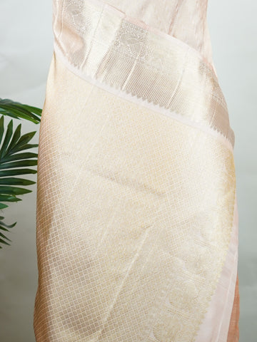 Kanchipuram Silk This 100% Pure Silk  silk saree, adorned in Peach and detailed with Pure Zari weaving, reflects the grandeur of Maharashtra. The timeless Buttis motifs enhance its bridal charm. A perfect blend of luxury and tradition, it is designed for those who appreciate fine craftsmanship. Rageshree - Peach Pure Kanjivaram Silk Saree | Pure Zari - Manoranjitham Weaves - Handloom Store