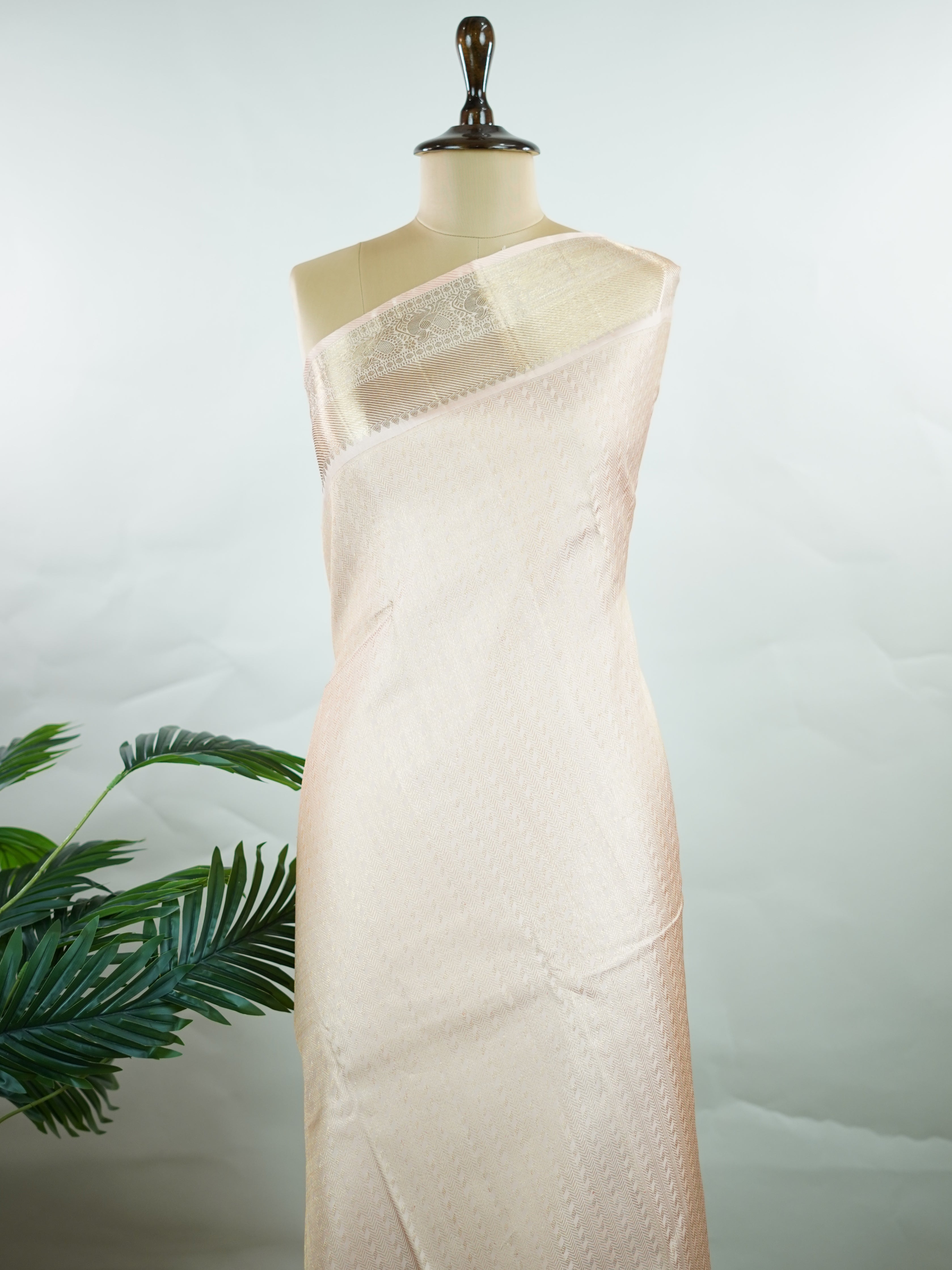 Kanchipuram Silk This 100% Pure Silk  silk saree, adorned in Peach and detailed with Pure Zari weaving, reflects the grandeur of Maharashtra. The timeless Buttis motifs enhance its bridal charm. A perfect blend of luxury and tradition, it is designed for those who appreciate fine craftsmanship. Rageshree - Peach Pure Kanjivaram Silk Saree | Pure Zari - Manoranjitham Weaves - Handloom Store