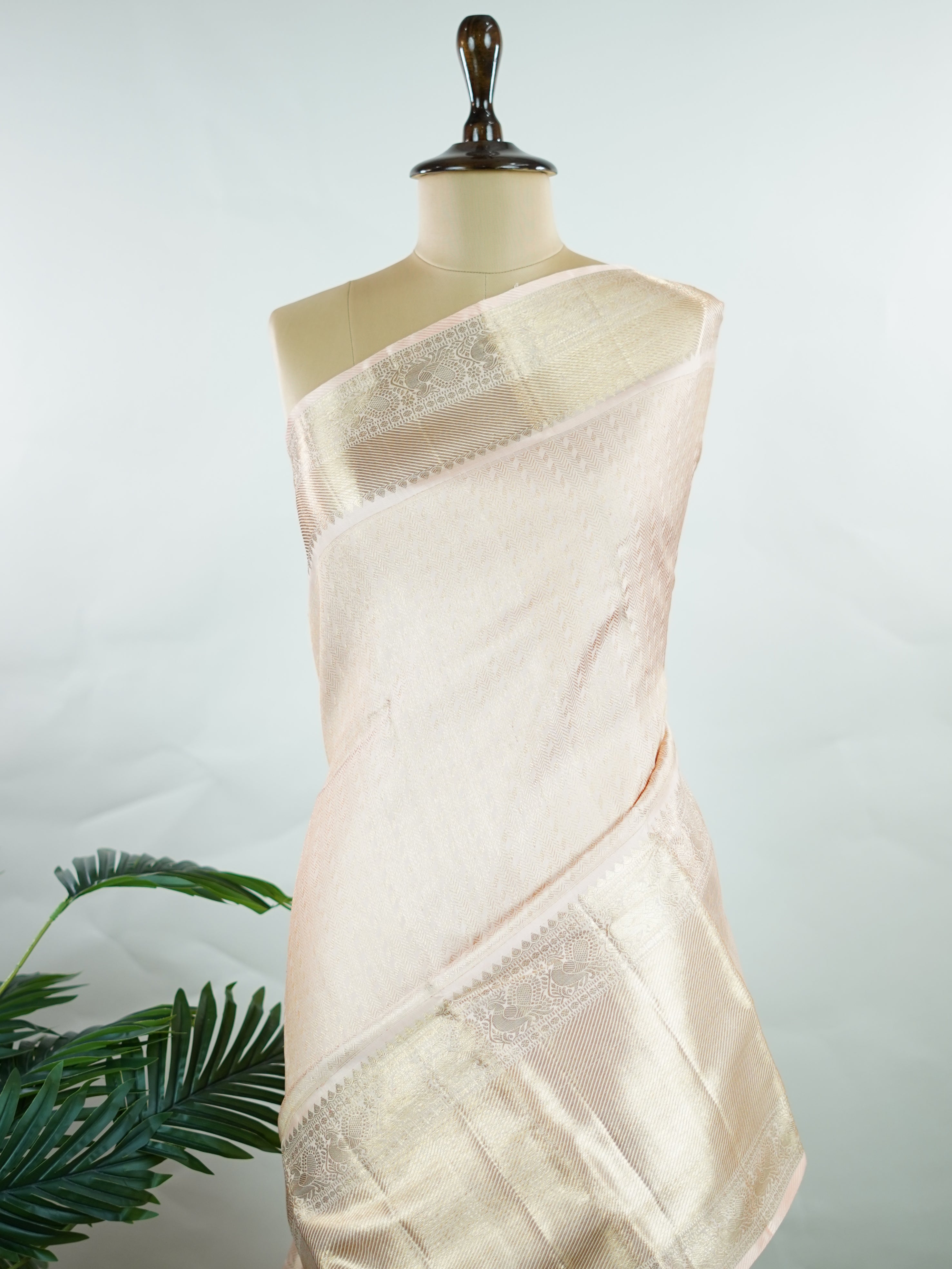 Kanchipuram Silk This 100% Pure Silk  silk saree, adorned in Peach and detailed with Pure Zari weaving, reflects the grandeur of Maharashtra. The timeless Buttis motifs enhance its bridal charm. A perfect blend of luxury and tradition, it is designed for those who appreciate fine craftsmanship. Rageshree - Peach Pure Kanjivaram Silk Saree | Pure Zari - Manoranjitham Weaves - Handloom Store