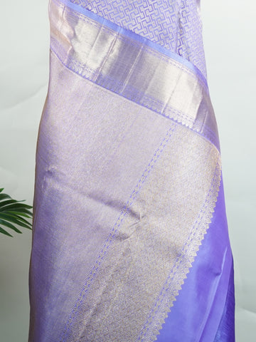 Kanchipuram Silk A masterpiece from Maharashtra, this 100% Pure Silk  saree in Orchid Blue is a tribute to India's rich handloom legacy. The Pure Zari weaving and Buttis motifs make it a perfect choice for brides and celebrations. Every thread speaks of elegance, tradition, and the skilled hands that bring this saree to life. Kaunsi - Pure Kanjivaram Silk Saree | Pure Zari - Manoranjitham Weaves - Handloom Store