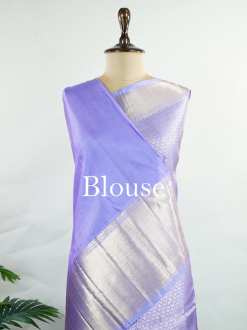 Kanchipuram Silk A masterpiece from Maharashtra, this 100% Pure Silk  saree in Orchid Blue is a tribute to India's rich handloom legacy. The Pure Zari weaving and Buttis motifs make it a perfect choice for brides and celebrations. Every thread speaks of elegance, tradition, and the skilled hands that bring this saree to life. Kaunsi - Pure Kanjivaram Silk Saree | Pure Zari - Manoranjitham Weaves - Handloom Store