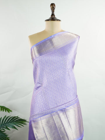 Kanchipuram Silk A masterpiece from Maharashtra, this 100% Pure Silk  saree in Orchid Blue is a tribute to India's rich handloom legacy. The Pure Zari weaving and Buttis motifs make it a perfect choice for brides and celebrations. Every thread speaks of elegance, tradition, and the skilled hands that bring this saree to life. Kaunsi - Pure Kanjivaram Silk Saree | Pure Zari - Manoranjitham Weaves - Handloom Store