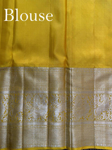 Kanchipuram Silk A masterpiece from Maharashtra, this 100% Pure Silk  saree in Golden Yellow is a tribute to India's rich handloom legacy. The Pure Zari weaving and Buttis motifs make it a perfect choice for brides and celebrations. Every thread speaks of elegance, tradition, and the skilled hands that bring this saree to life. Jogiya - Pure Kanjivaram Silk Saree - Manoranjitham Weaves - Handloom Store