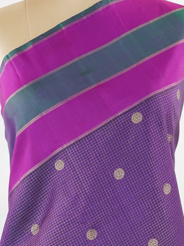 Kanchipuram Silk Experience the elegance of this pure Zari Oosi Kattam saree from Kanchipuram, featuring intricate gold and silver threads woven into a rich purple fabric. The vibrant multi-gap borders in pink and green add a striking contrast, perfect for festive occasions. This masterpiece combines comfort and artistry, making it a timeless choice for celebrations. Padma - Manoranjitham Weaves - Handloom Store