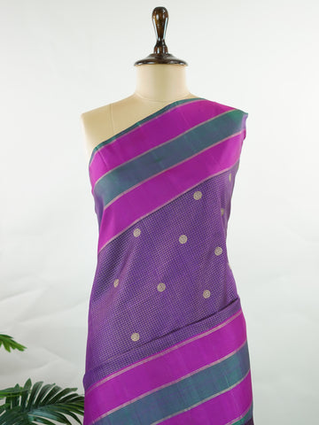 Kanchipuram Silk Experience the elegance of this pure Zari Oosi Kattam saree from Kanchipuram, featuring intricate gold and silver threads woven into a rich purple fabric. The vibrant multi-gap borders in pink and green add a striking contrast, perfect for festive occasions. This masterpiece combines comfort and artistry, making it a timeless choice for celebrations. Padma - Manoranjitham Weaves - Handloom Store