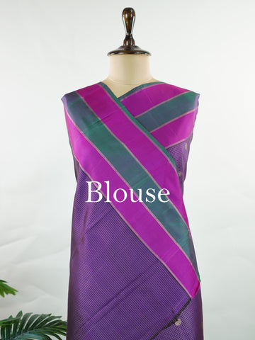 Kanchipuram Silk Experience the elegance of this pure Zari Oosi Kattam saree from Kanchipuram, featuring intricate gold and silver threads woven into a rich purple fabric. The vibrant multi-gap borders in pink and green add a striking contrast, perfect for festive occasions. This masterpiece combines comfort and artistry, making it a timeless choice for celebrations. Padma - Manoranjitham Weaves - Handloom Store