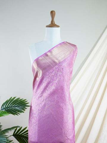 Kanchipuram Silk This Kanjivaram silk saree, adorned in Light Pink and detailed with Pure Zari weaving, reflects the grandeur of Kanchipuram. The timeless Buttis motifs enhance its bridal charm. A perfect blend of luxury and tradition, it is designed for those who appreciate fine craftsmanship. Sindhu - Manoranjitham Weaves - Handloom Store