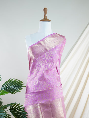 Kanchipuram Silk This Kanjivaram silk saree, adorned in Light Pink and detailed with Pure Zari weaving, reflects the grandeur of Kanchipuram. The timeless Buttis motifs enhance its bridal charm. A perfect blend of luxury and tradition, it is designed for those who appreciate fine craftsmanship. Sindhu - Manoranjitham Weaves - Handloom Store