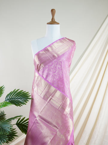 Kanchipuram Silk This Kanjivaram silk saree, adorned in Light Pink and detailed with Pure Zari weaving, reflects the grandeur of Kanchipuram. The timeless Buttis motifs enhance its bridal charm. A perfect blend of luxury and tradition, it is designed for those who appreciate fine craftsmanship. Sindhu - Manoranjitham Weaves - Handloom Store
