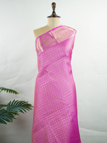 Kanchipuram Silk Beautiful vintage Kanjivaram saree featuring a charming Pink body, perfectly complemented by a matching Pink border and elegant Pink pallu. The monochromatic pink palette exudes grace, femininity, and timeless traditional beauty. Expertly woven with heritage craftsmanship, the saree reflects vintage elegance with a soft and sophisticated appeal. Paired with a plain Pink blouse, this exquisite drape is ideal for weddings, festive celebrations, and special occasions. Vareshni - Pure Kanjivara