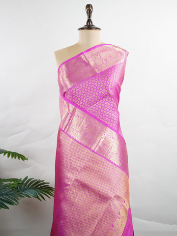 Kanchipuram Silk Beautiful vintage Kanjivaram saree featuring a charming Pink body, perfectly complemented by a matching Pink border and elegant Pink pallu. The monochromatic pink palette exudes grace, femininity, and timeless traditional beauty. Expertly woven with heritage craftsmanship, the saree reflects vintage elegance with a soft and sophisticated appeal. Paired with a plain Pink blouse, this exquisite drape is ideal for weddings, festive celebrations, and special occasions. Vareshni - Pure Kanjivara