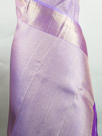 Kanchipuram Silk Beautiful bridal Kanjivaram saree featuring a dreamy Lavender body, elegantly paired with a matching Lavender border and graceful Lavender pallu Blouse. The soothing monochromatic palette exudes sophistication, romance, and timeless bridal charm. Expertly woven with exquisite craftsmanship, the saree radiates luxury and elegance with every drape. Paired with a plain Lavender blouse, this enchanting creation is perfect for weddings, receptions, and grand celebrations. Rithviga - Pure Kanjiva
