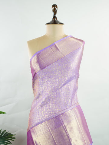 Kanchipuram Silk Beautiful bridal Kanjivaram saree featuring a dreamy Lavender body, elegantly paired with a matching Lavender border and graceful Lavender pallu Blouse. The soothing monochromatic palette exudes sophistication, romance, and timeless bridal charm. Expertly woven with exquisite craftsmanship, the saree radiates luxury and elegance with every drape. Paired with a plain Lavender blouse, this enchanting creation is perfect for weddings, receptions, and grand celebrations. Rithviga - Pure Kanjiva