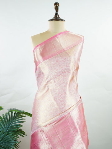 Kanchipuram Silk Beautiful bridal Kanjivaram saree featuring a delicate Pastel Pink body, elegantly paired with a matching border, pallu, and blouse. The soft pastel hue radiates grace and romance, creating a timeless and sophisticated bridal look. Exquisitely woven with traditional Kanjivaram craftsmanship, the saree blends heritage charm with modern elegance. A stunning choice for weddings and special celebrations, this enchanting drape embodies beauty, refinement, and bridal splendor. Darsitha - Pure Kan