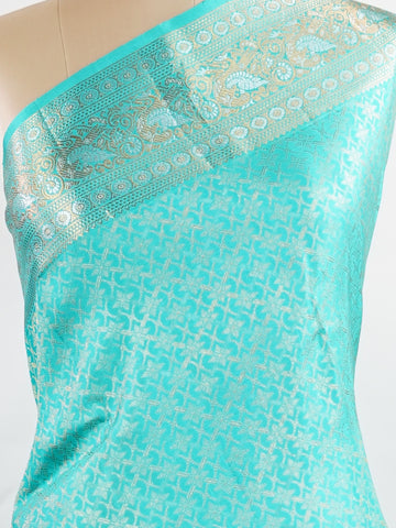 Kanchipuram Silk A pure Kanchipuram silk in tranquil cyan, adorned with gold and silver zari buttas. The self-border enhances the saree's seamless elegance, making it an exquisite choice for celebrations. Woven with precision, this handloom drape is a timeless ode to tradition.    #ManoranjithamSilks #KanjivaramHandloom #PureSilkSaree #BridalElegance #TimelessTradition Charukesi - Pure Kanjivaram Silk Saree | Zari Buttas - Manoranjitham Weaves - Handloom Store