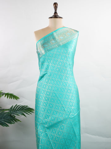 Kanchipuram Silk A pure Kanchipuram silk in tranquil cyan, adorned with gold and silver zari buttas. The self-border enhances the saree's seamless elegance, making it an exquisite choice for celebrations. Woven with precision, this handloom drape is a timeless ode to tradition.    #ManoranjithamSilks #KanjivaramHandloom #PureSilkSaree #BridalElegance #TimelessTradition Charukesi - Pure Kanjivaram Silk Saree | Zari Buttas - Manoranjitham Weaves - Handloom Store