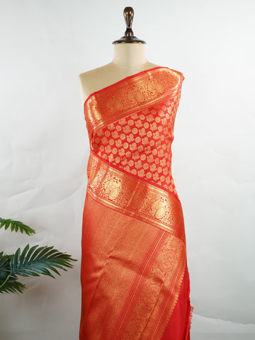Kanchipuram Silk A radiant red Kanchipuram silk, embellished with delicate gold zari buttas across its expanse. The self-border adds understated grace, perfect for bridal elegance and festive occasions. This timeless weave reflects the grandeur of South Indian handloom heritage.     #ManoranjithamSilks #KanjivaramHandloom #PureSilkSaree #BridalElegance #TimelessTradition Harikambhoji - Pure Kanjivaram Silk Saree | Zari Buttas - Manoranjitham Weaves - Handloom Store