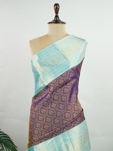 Kanchipuram Silk A regal burgundy Kanchipuram silk saree, woven from 100% pure silk with shimmering gold zari buttas adorning its body. The striking cyan border adds a vibrant contrast, making this drape perfect for grand occasions. Every weave echoes timeless tradition and handloom excellence. The rich hues speak of royal heritage, while the intricate zari work whispers stories of artisanal mastery. A timeless piece, crafted to grace your most cherished moments.          #ManoranjithamSilks #KanjivaramHand