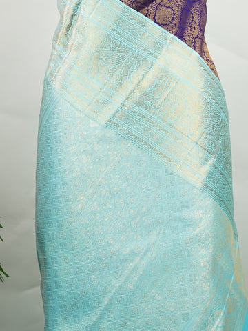 Kanchipuram Silk A regal burgundy Kanchipuram silk saree, woven from 100% pure silk with shimmering gold zari buttas adorning its body. The striking cyan border adds a vibrant contrast, making this drape perfect for grand occasions. Every weave echoes timeless tradition and handloom excellence. The rich hues speak of royal heritage, while the intricate zari work whispers stories of artisanal mastery. A timeless piece, crafted to grace your most cherished moments.          #ManoranjithamSilks #KanjivaramHand
