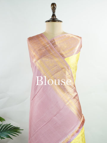 Kanchipuram Silk A radiant yellow Kanchipuram silk saree embellished with gold zari buttas, capturing the warmth of sunlight in every weave. The pink border adds a playful contrast, making it perfect for auspicious celebrations. Crafted from 100% pure silk, this handloom treasure carries the essence of timeless tradition. A saree designed to grace festive moments and bridal occasions.      #ManoranjithamSilks #KanjivaramHandloom #PureSilkSaree #BridalElegance #TimelessTradition Sarasangi - Pure Kanjivaram S