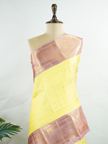 Kanchipuram Silk A radiant yellow Kanchipuram silk saree embellished with gold zari buttas, capturing the warmth of sunlight in every weave. The pink border adds a playful contrast, making it perfect for auspicious celebrations. Crafted from 100% pure silk, this handloom treasure carries the essence of timeless tradition. A saree designed to grace festive moments and bridal occasions.      #ManoranjithamSilks #KanjivaramHandloom #PureSilkSaree #BridalElegance #TimelessTradition Sarasangi - Pure Kanjivaram S