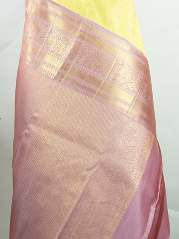 Kanchipuram Silk A radiant yellow Kanchipuram silk saree embellished with gold zari buttas, capturing the warmth of sunlight in every weave. The pink border adds a playful contrast, making it perfect for auspicious celebrations. Crafted from 100% pure silk, this handloom treasure carries the essence of timeless tradition. A saree designed to grace festive moments and bridal occasions.      #ManoranjithamSilks #KanjivaramHandloom #PureSilkSaree #BridalElegance #TimelessTradition Sarasangi - Pure Kanjivaram S