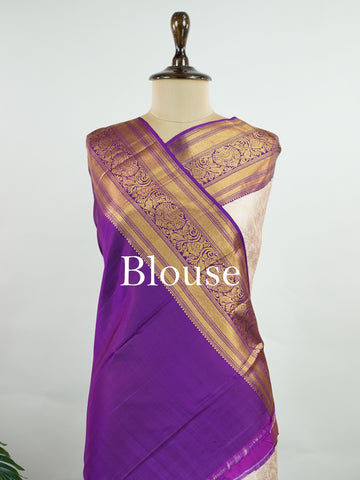 Kanchipuram Silk A soft peach Kanchipuram silk saree adorned with gold zari buttas, exuding subtle grace. The deep burgundy border offers a striking contrast, elevating the timeless beauty of this weave. Woven from 100% pure silk, this saree blends tradition with understated luxury. Ideal for weddings and festive occasions.         #ManoranjithamSilks #KanjivaramHandloom #PureSilkSaree #BridalElegance #TimelessTradition Sahana - Pure Kanjivaram Silk Saree | Zari Buttas - Manoranjitham Weaves - Handloom Stor