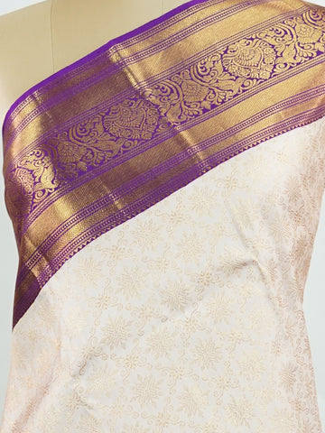 Kanchipuram Silk A soft peach Kanchipuram silk saree adorned with gold zari buttas, exuding subtle grace. The deep burgundy border offers a striking contrast, elevating the timeless beauty of this weave. Woven from 100% pure silk, this saree blends tradition with understated luxury. Ideal for weddings and festive occasions.         #ManoranjithamSilks #KanjivaramHandloom #PureSilkSaree #BridalElegance #TimelessTradition Sahana - Pure Kanjivaram Silk Saree | Zari Buttas - Manoranjitham Weaves - Handloom Stor