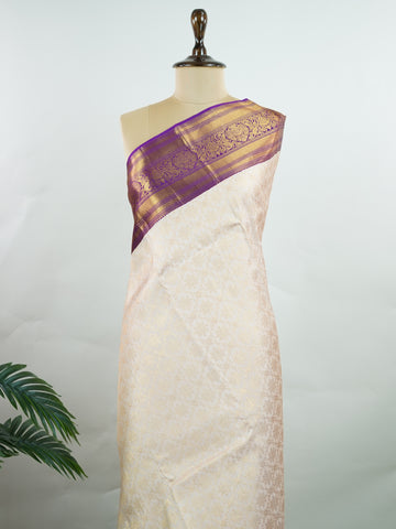 Kanchipuram Silk A soft peach Kanchipuram silk saree adorned with gold zari buttas, exuding subtle grace. The deep burgundy border offers a striking contrast, elevating the timeless beauty of this weave. Woven from 100% pure silk, this saree blends tradition with understated luxury. Ideal for weddings and festive occasions.         #ManoranjithamSilks #KanjivaramHandloom #PureSilkSaree #BridalElegance #TimelessTradition Sahana - Pure Kanjivaram Silk Saree | Zari Buttas - Manoranjitham Weaves - Handloom Stor