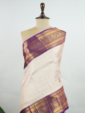 Kanchipuram Silk A soft peach Kanchipuram silk saree adorned with gold zari buttas, exuding subtle grace. The deep burgundy border offers a striking contrast, elevating the timeless beauty of this weave. Woven from 100% pure silk, this saree blends tradition with understated luxury. Ideal for weddings and festive occasions.         #ManoranjithamSilks #KanjivaramHandloom #PureSilkSaree #BridalElegance #TimelessTradition Sahana - Pure Kanjivaram Silk Saree | Zari Buttas - Manoranjitham Weaves - Handloom Stor