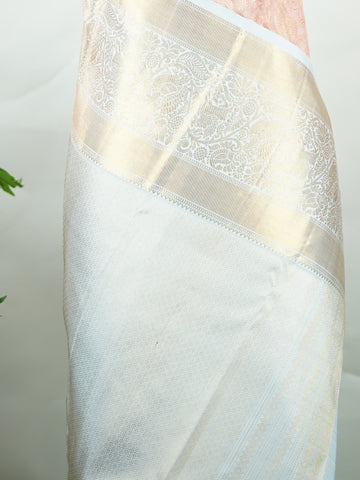 Kanchipuram Silk A captivating coral Kanchipuram silk saree woven with gold zari buttas, radiating charm and grace. The contrast lavender border adds a gentle elegance to the weave. Crafted from 100% pure silk, this timeless creation is perfect for weddings and festive moments.            #ManoranjithamSilks #KanjivaramHandloom #PureSilkSaree #BridalElegance #TimelessTradition Pantuvarali - Pure Kanjivaram Silk Saree | Zari Buttas - Manoranjitham Weaves - Handloom Store