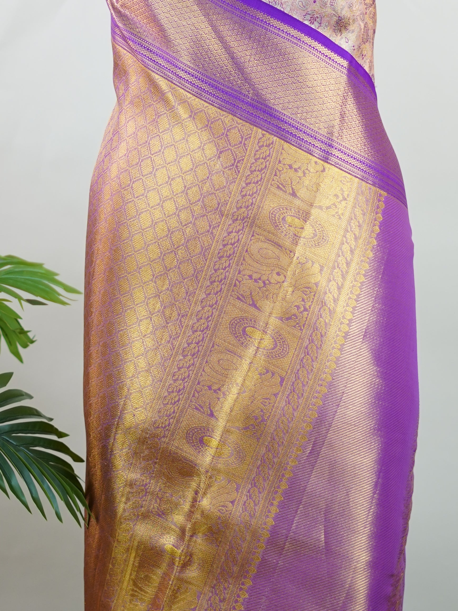 Kanchipuram Silk Soft peach silk meets purple borders, woven with gold and silver zari buttas that shimmer in every glance. This saree blends grace with tradition, perfect for festive moments. Crafted from 100% pure silk, it carries the artistry of timeless handlooms. A drape to cherish forever.                #ManoranjithamSilks #KanjivaramHandloom #PureSilkSaree #BridalElegance #TimelessTradition Sindhu - Peach Pure Kanjivaram Silk Saree | Zari Buttas - Manoranjitham Weaves - Handloom Store