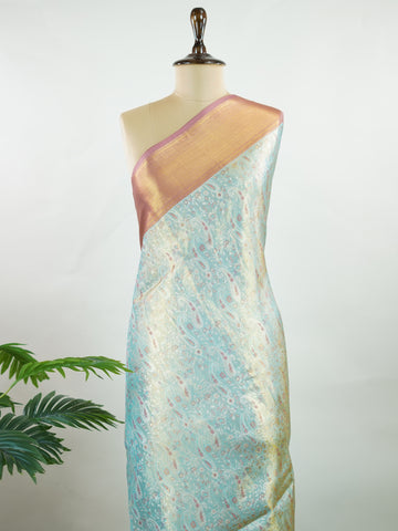 Kanchipuram Silk Earthy olive green silk paired with red borders, woven with gold and silver zari buttas that glimmer softly. This saree blends tradition with understated elegance. Made from 100% pure silk, it speaks of timeless beauty. A perfect drape for weddings and special occasions.            #ManoranjithamSilks #KanjivaramHandloom #PureSilkSaree #BridalElegance #TimelessTradition Gowrimanohari - Green Pure Kanjivaram Silk Saree | Zari Buttas - Manoranjitham Weaves - Handloom Store