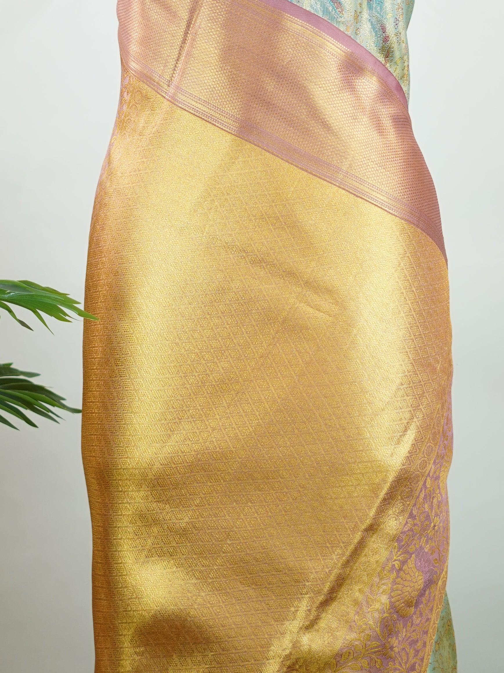 Kanchipuram Silk Earthy olive green silk paired with red borders, woven with gold and silver zari buttas that glimmer softly. This saree blends tradition with understated elegance. Made from 100% pure silk, it speaks of timeless beauty. A perfect drape for weddings and special occasions.            #ManoranjithamSilks #KanjivaramHandloom #PureSilkSaree #BridalElegance #TimelessTradition Gowrimanohari - Green Pure Kanjivaram Silk Saree | Zari Buttas - Manoranjitham Weaves - Handloom Store
