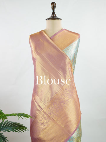 Kanchipuram Silk Earthy olive green silk paired with red borders, woven with gold and silver zari buttas that glimmer softly. This saree blends tradition with understated elegance. Made from 100% pure silk, it speaks of timeless beauty. A perfect drape for weddings and special occasions.            #ManoranjithamSilks #KanjivaramHandloom #PureSilkSaree #BridalElegance #TimelessTradition Gowrimanohari - Green Pure Kanjivaram Silk Saree | Zari Buttas - Manoranjitham Weaves - Handloom Store
