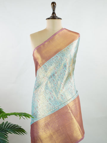 Kanchipuram Silk Earthy olive green silk paired with red borders, woven with gold and silver zari buttas that glimmer softly. This saree blends tradition with understated elegance. Made from 100% pure silk, it speaks of timeless beauty. A perfect drape for weddings and special occasions.            #ManoranjithamSilks #KanjivaramHandloom #PureSilkSaree #BridalElegance #TimelessTradition Gowrimanohari - Green Pure Kanjivaram Silk Saree | Zari Buttas - Manoranjitham Weaves - Handloom Store