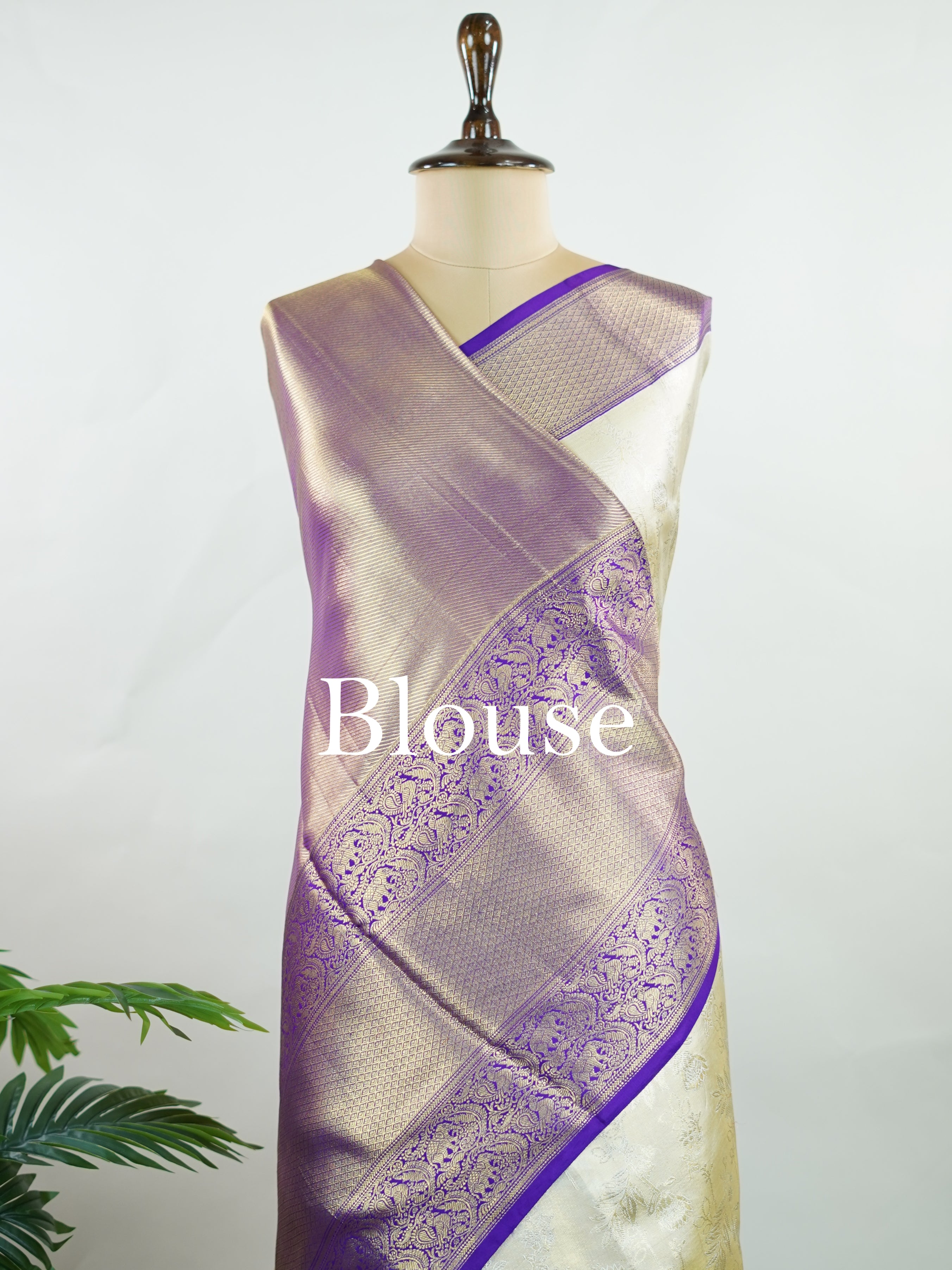 Kanchipuram Silk A classic cream silk saree with purple borders, adorned with delicate zari buttis scattered across the weave. The rich contrast blends tradition with grace. Woven in Kanchipuram from 100% pure silk, it's perfect for weddings and festive occasions. A timeless drape for treasured moments.                     #ManoranjithamSilks #KanjivaramHandloom #PureSilkSaree #BridalElegance #TimelessTradition Vagadeeshwari - Cream Pure Kanjivaram Silk Saree | Zari Buttas - Manoranjitham Weaves - Handloom 