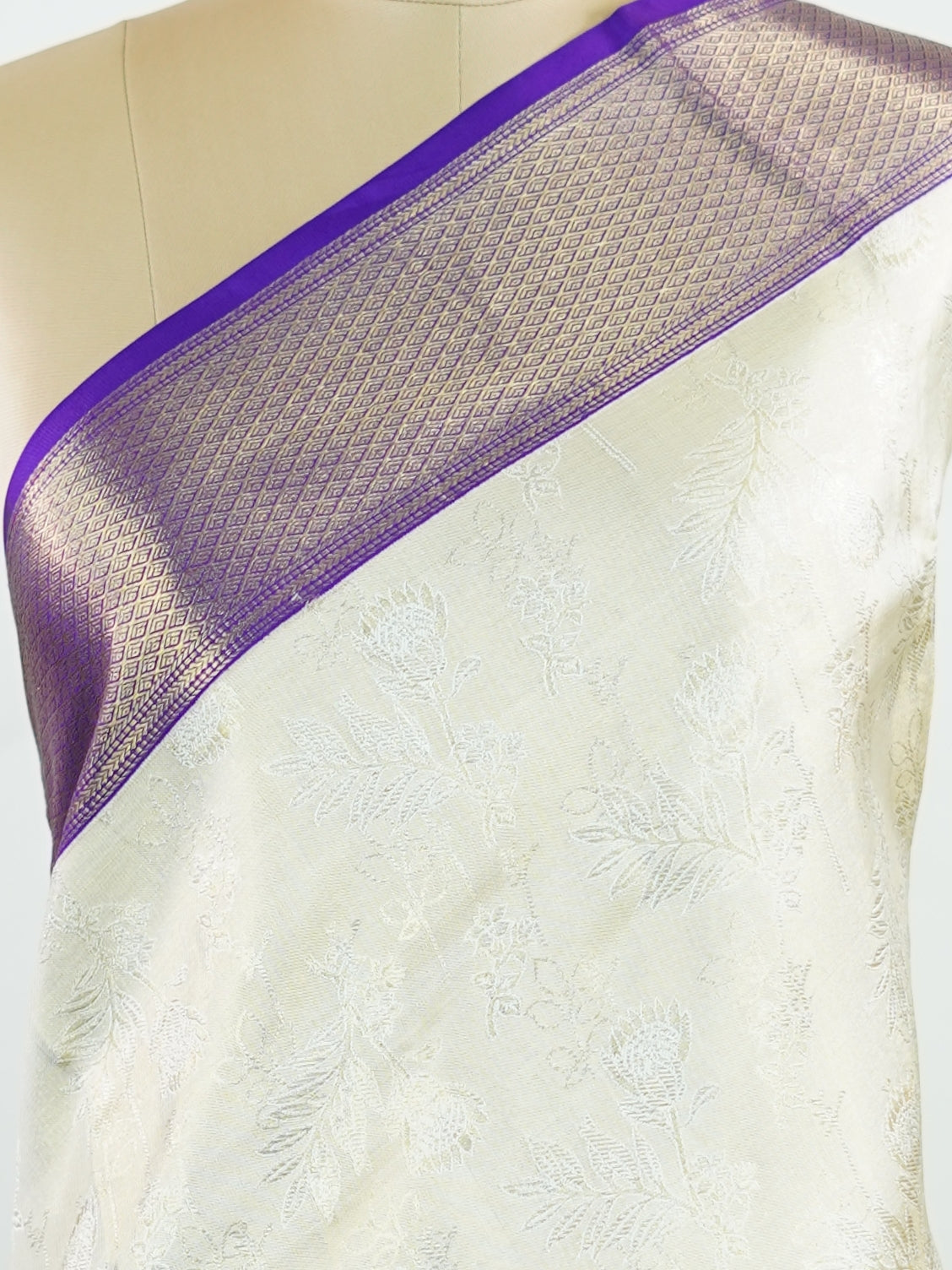 Kanchipuram Silk A classic cream silk saree with purple borders, adorned with delicate zari buttis scattered across the weave. The rich contrast blends tradition with grace. Woven in Kanchipuram from 100% pure silk, it's perfect for weddings and festive occasions. A timeless drape for treasured moments.                     #ManoranjithamSilks #KanjivaramHandloom #PureSilkSaree #BridalElegance #TimelessTradition Vagadeeshwari - Cream Pure Kanjivaram Silk Saree | Zari Buttas - Manoranjitham Weaves - Handloom 