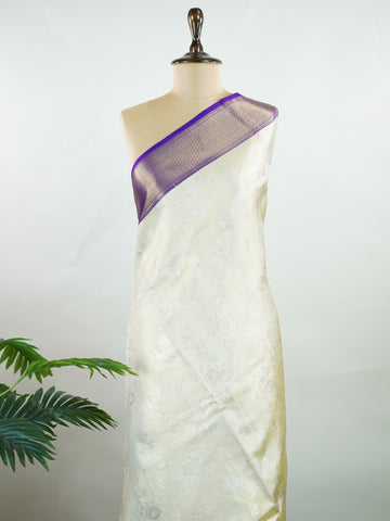 Kanchipuram Silk A classic cream silk saree with purple borders, adorned with delicate zari buttis scattered across the weave. The rich contrast blends tradition with grace. Woven in Kanchipuram from 100% pure silk, it's perfect for weddings and festive occasions. A timeless drape for treasured moments.                     #ManoranjithamSilks #KanjivaramHandloom #PureSilkSaree #BridalElegance #TimelessTradition Vagadeeshwari - Cream Pure Kanjivaram Silk Saree | Zari Buttas - Manoranjitham Weaves - Handloom 